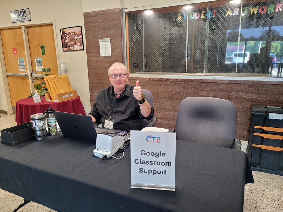 Photo of a CLEE Event Team Member offering Google Classroom tech support