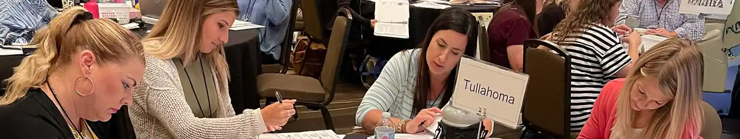 A photo of teachers at work around a conference table