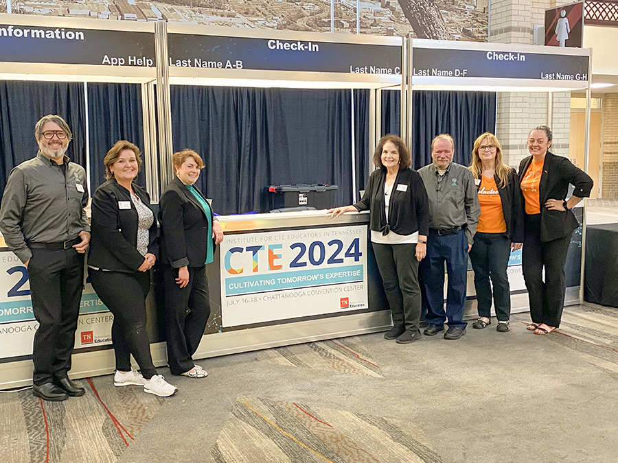 Photo of team with the CTE 2024 banner