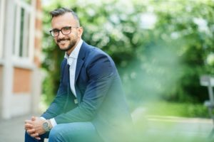 man in suit sitting outside