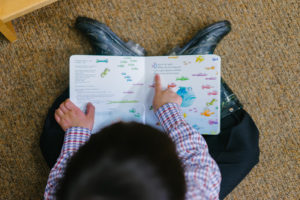 small child reading book