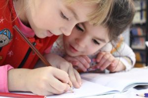 2 young students working in workbook