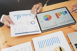 hands explaining charts and graphs