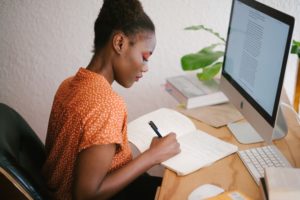 woman working at desk with laptop computer open