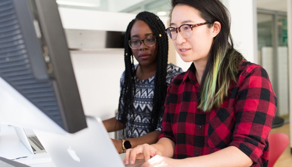 2 students working at desktop computer