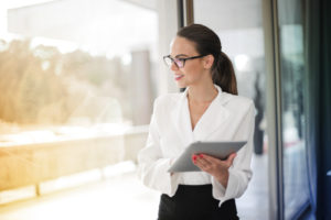 professional female standing by a window