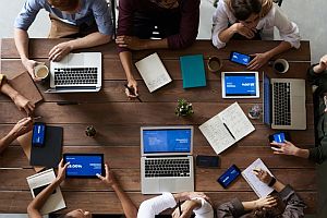 top view of group of professionls with laptops around a table