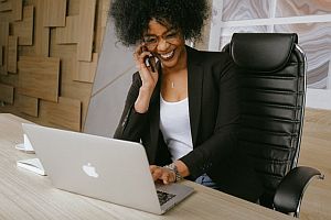 Woman at phone at laptop