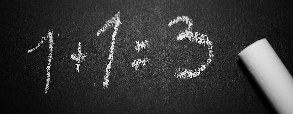 1+1=3 math problem written on chalkboard