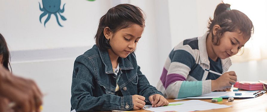 middle school students working at a table