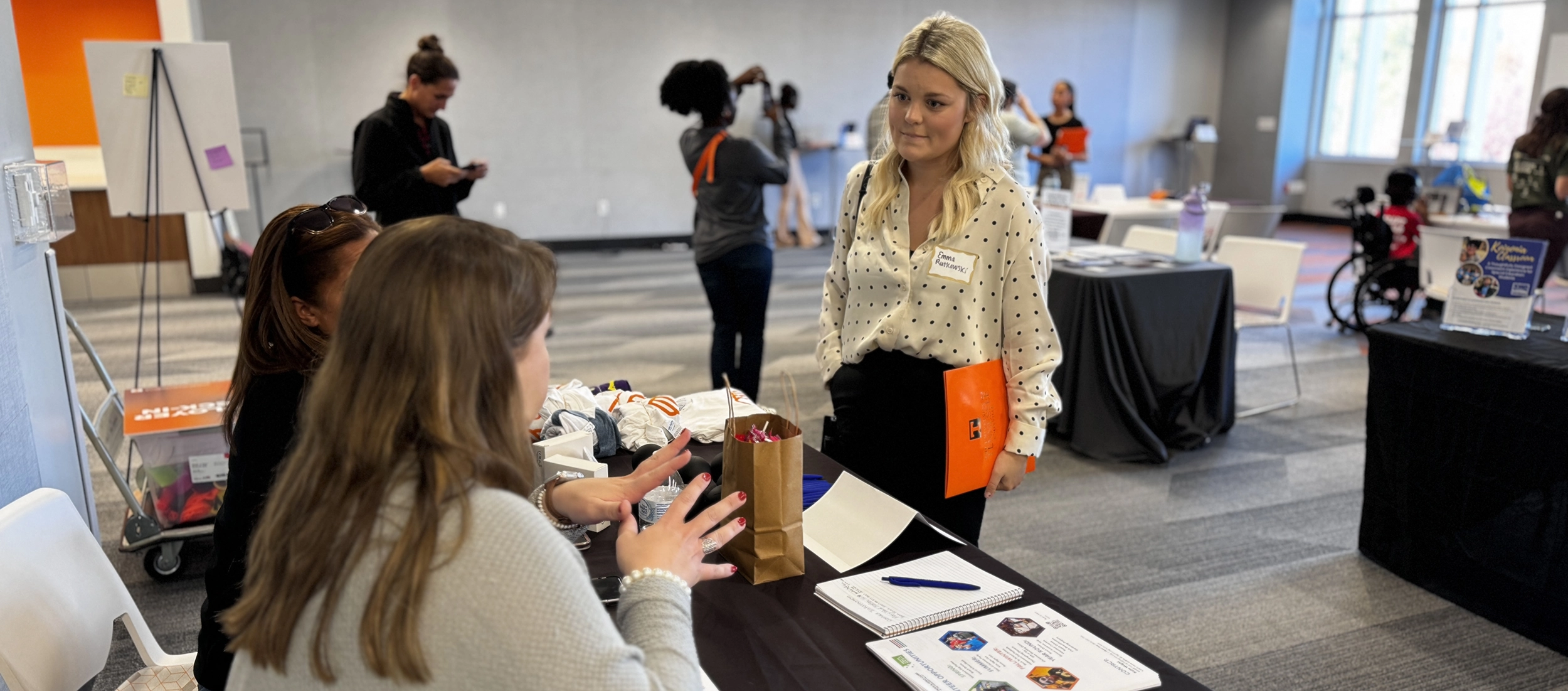 Students talking with employers at tables during a KRSS internship fair
