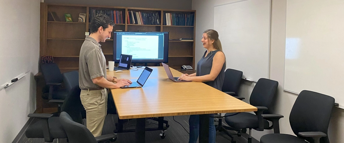 Researchers working at a conference table in the Applied Sport Psychology Laboratory