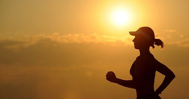 female exercising running in sunset
