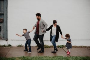 Family walking down sidewalk