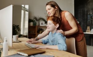 mother and boy working at computer