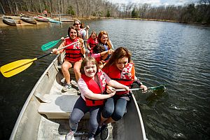 counselors and students in a canoe at camp koinonia