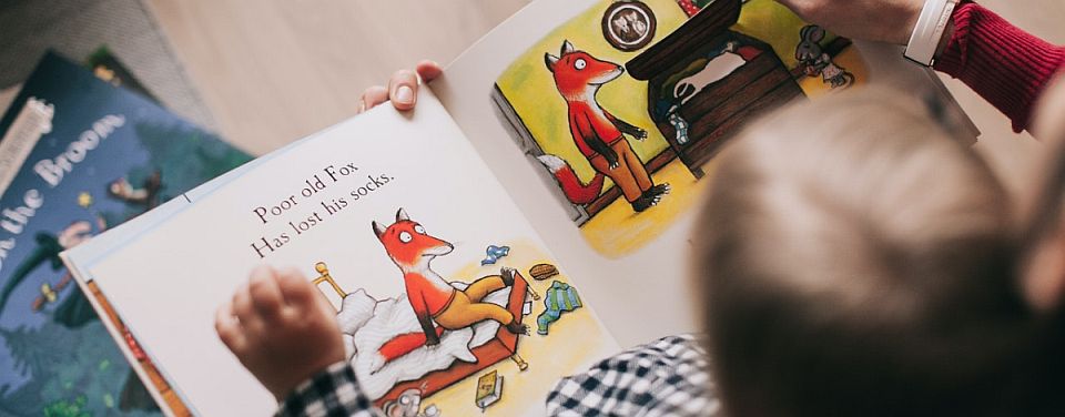 child reading a book about fox