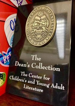 Plaque with the university's seal that says "The Dean's Collection | The Center for Children's & Young Adult Literature"