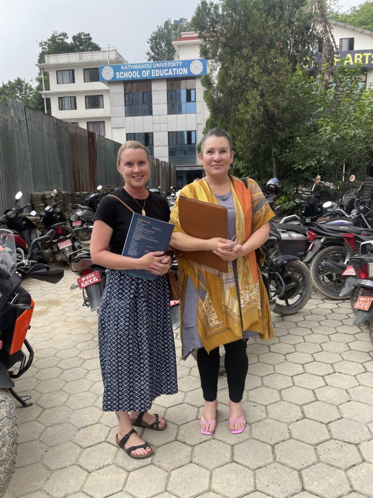 Samara Akpovo (right) and Sarah Neessen (left) pose in front of the Kathmandu University School of Education