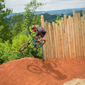 Photo of biker airborne as they travel down Knoxville Urban Wilderness bike trail.