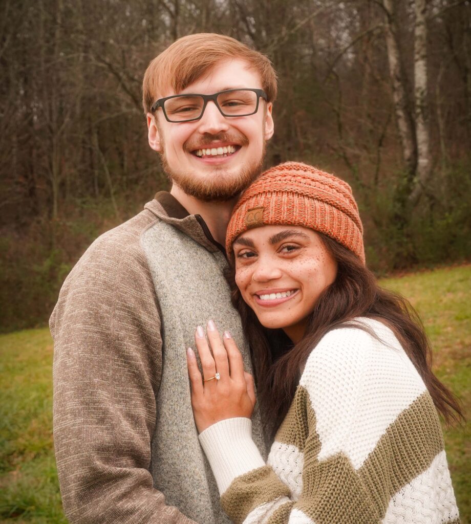 Picture of Kenzie and Tanner in front of wooded area.