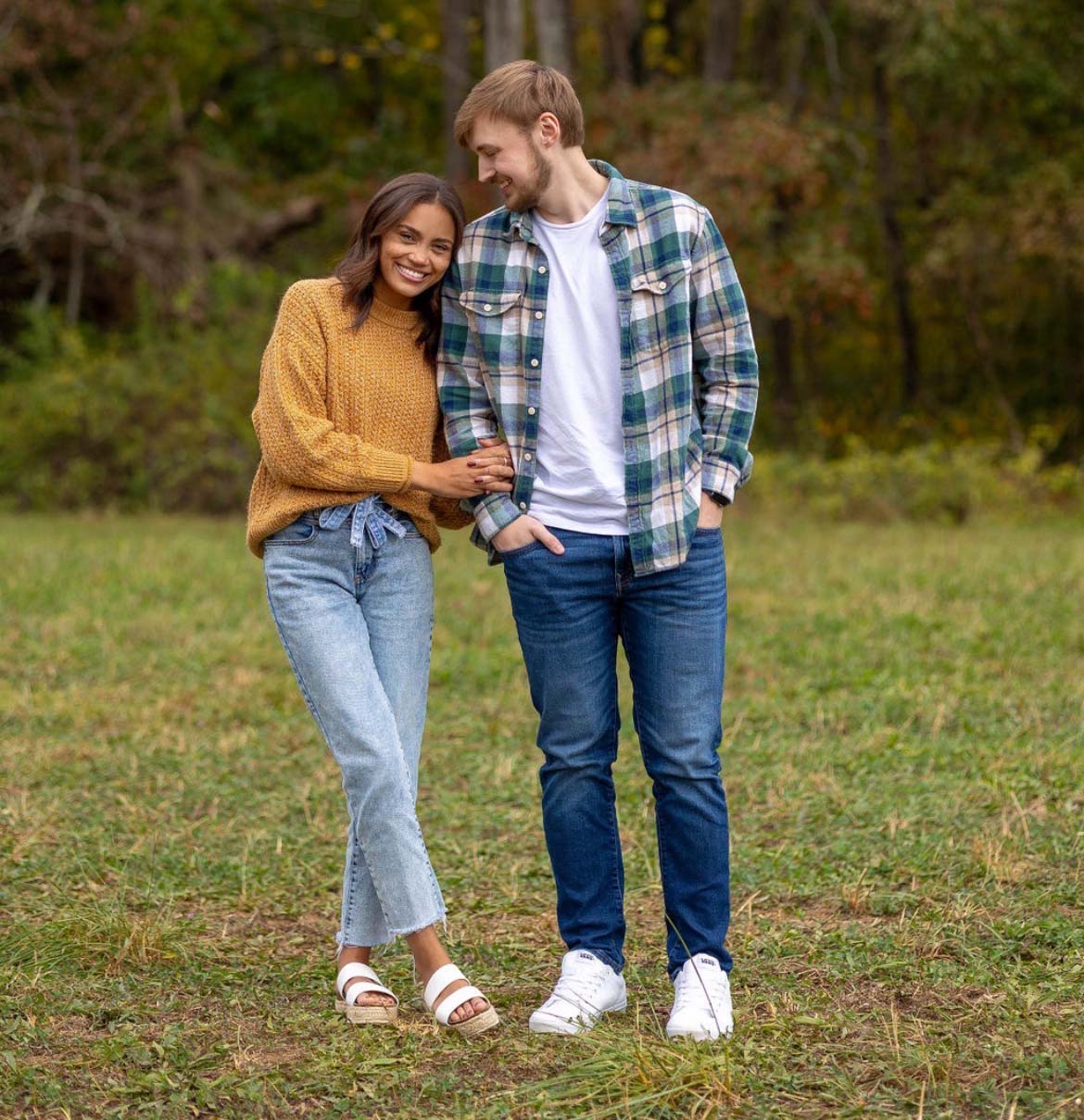 Picture of Kenzie and Tanner in front of a wooded area.